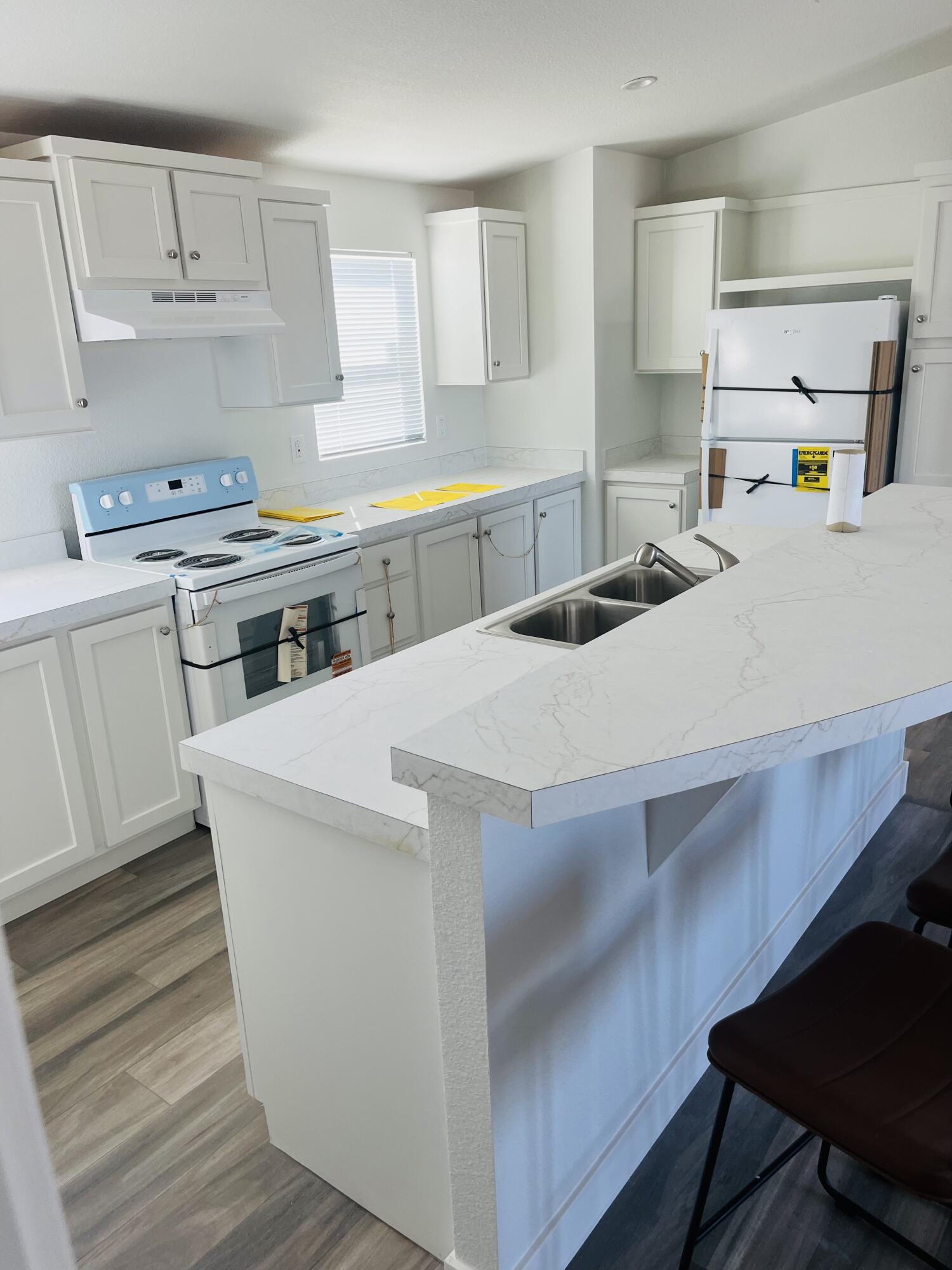 72360 Shell Drive Mecca, CA 92254 - Photo 2 of 4 a kitchen with kitchen island a stove a sink and a refrigerator
