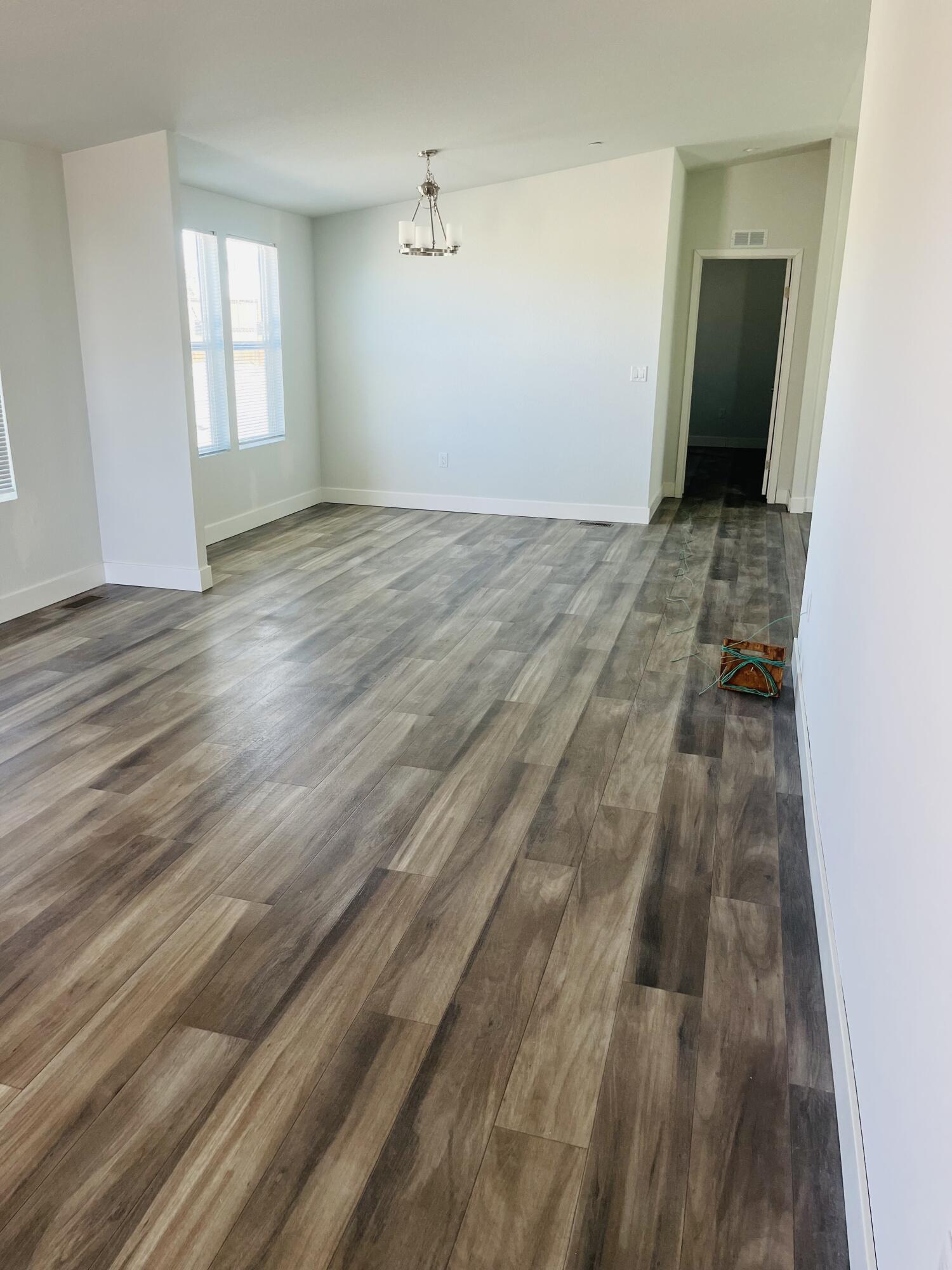 72360 Shell Drive Mecca, CA 92254 - Photo 3 of 4 an empty room with wooden floor and windows