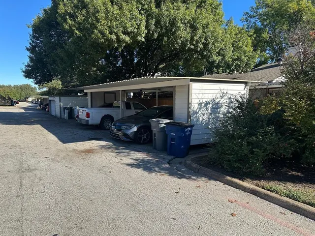 a view of a house with a large tree in a yard
