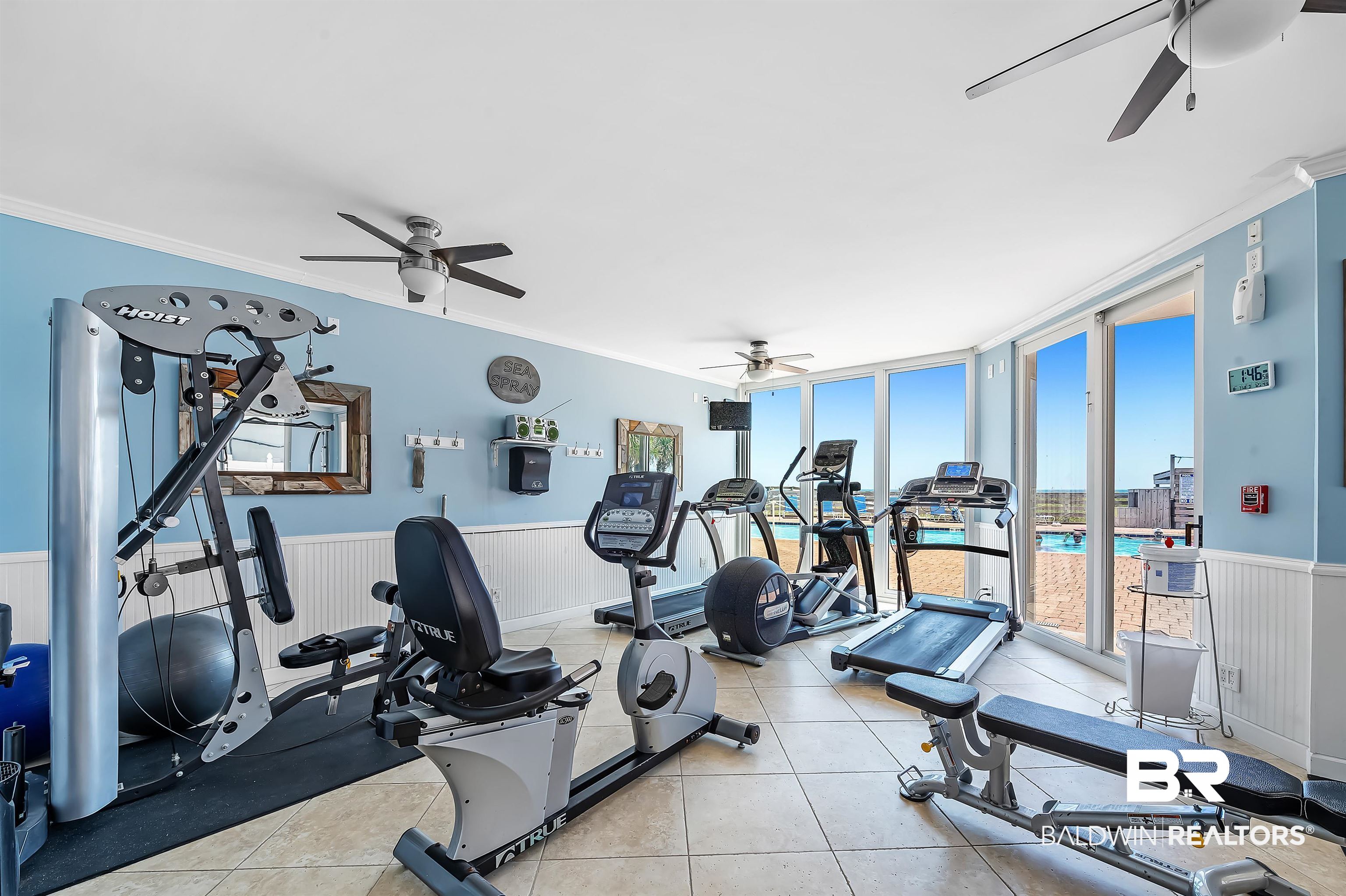 16287 Perdido Key Drive, Unit 105 Pensacola, FL 32507 - Photo 45 of 66 Fitness center featuring floor-to-ceiling windows, tile flooring, and multiple ceiling fans