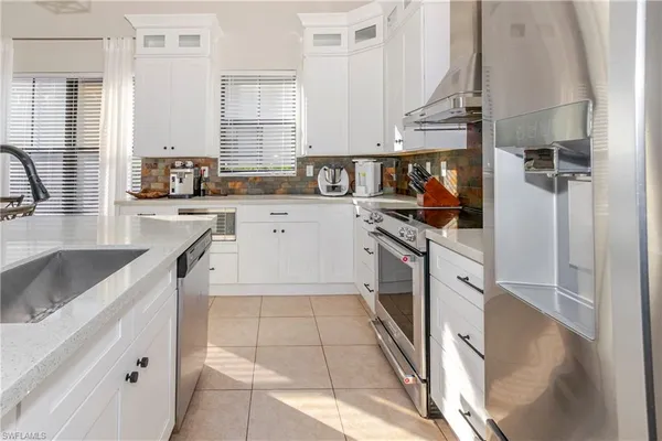 a kitchen with a sink a stove and cabinets