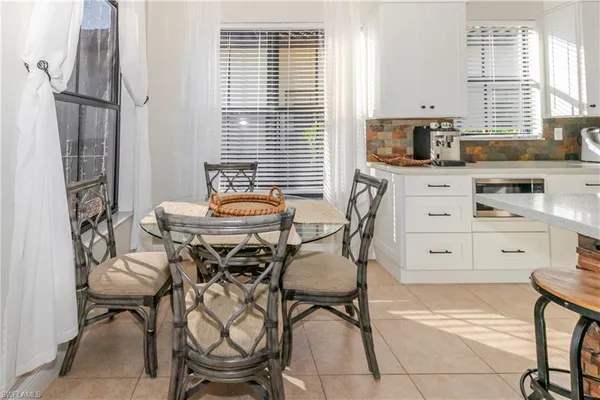 a view of a dining room with furniture and a window
