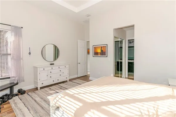 a bedroom with a bed and a mirror