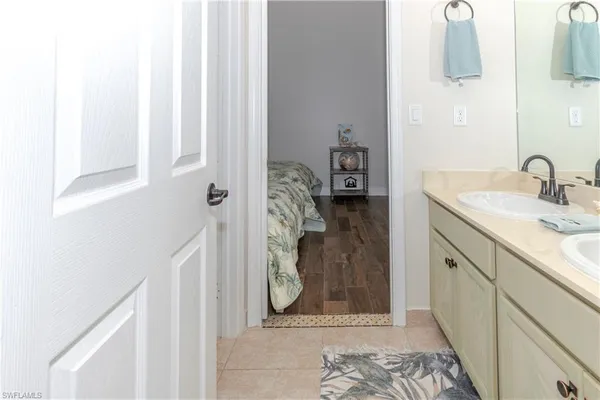 a bathroom with a granite countertop sink a mirror and shower
