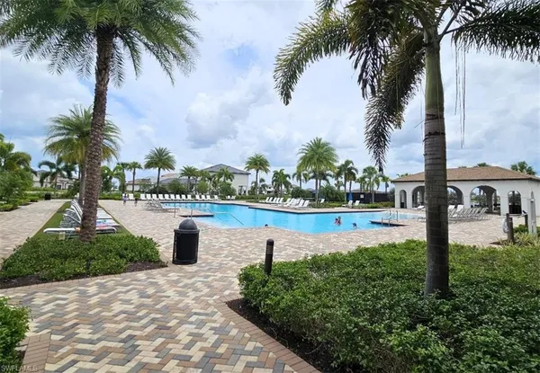 a view of swimming pool with outdoor seating and plants