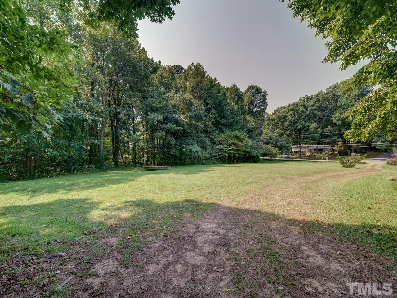 1241 Kingston Ridge Road Cary, NC 27511 - Photo 3 of 3 a view of a field with trees in the background