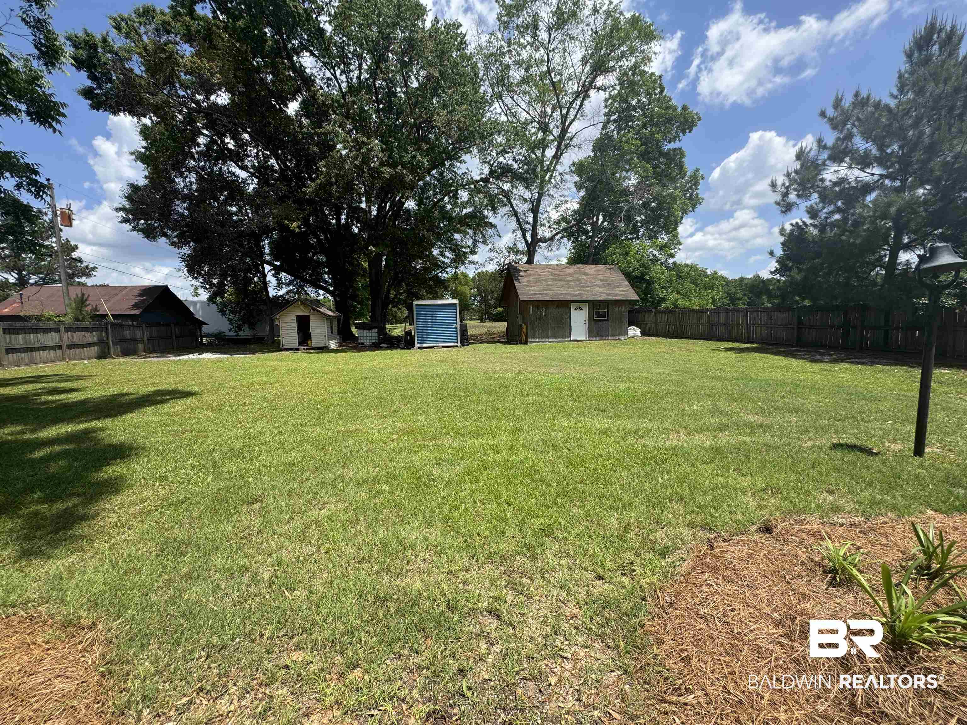 2274 Foshee Road Brewton, AL 36426 - Photo 21 of 23 Fenced backyard featuring a storage shed