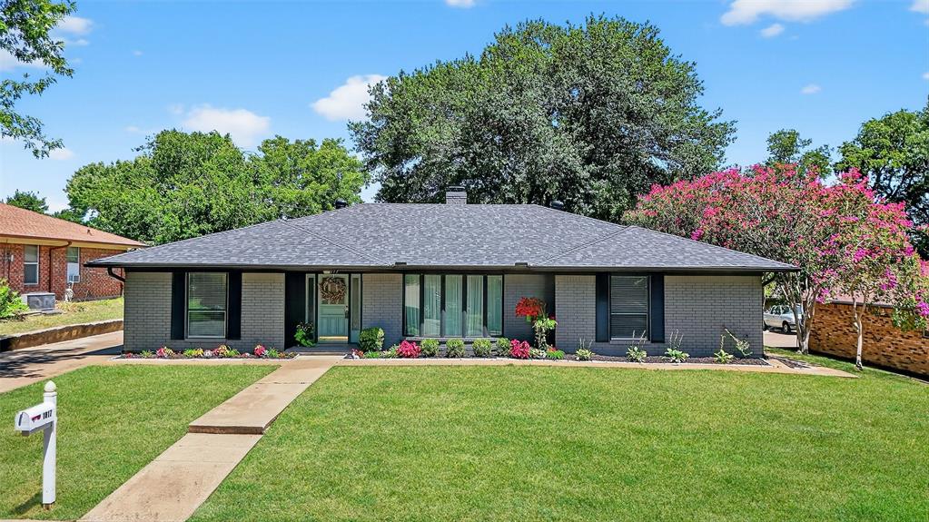 a front view of house with yard and green space