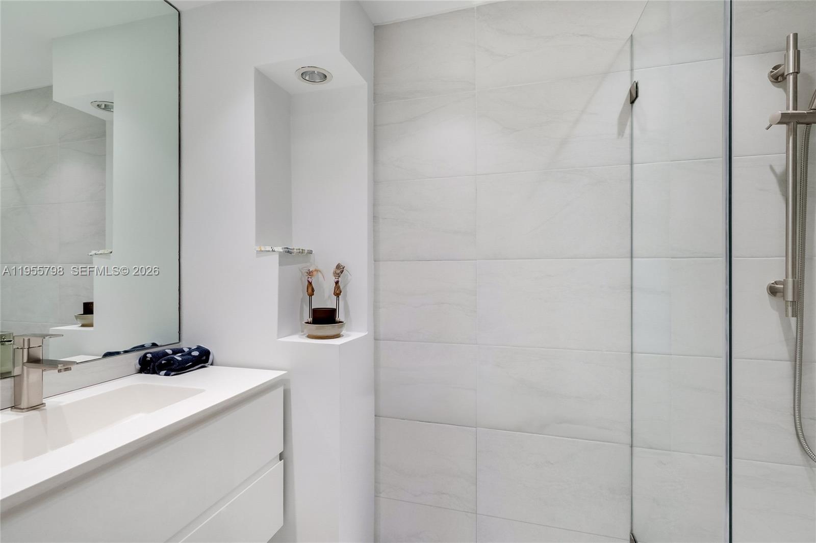 200 Southeast 15th Road, Unit 15C Miami, FL 33129 - Photo 13 of 31 a bathroom with a sink and a mirror