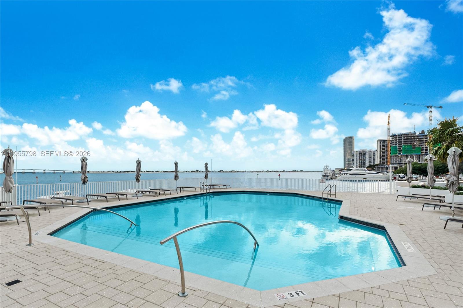 200 Southeast 15th Road, Unit 15C Miami, FL 33129 - Photo 21 of 31 a kitchen with a sink cabinets and chandelier