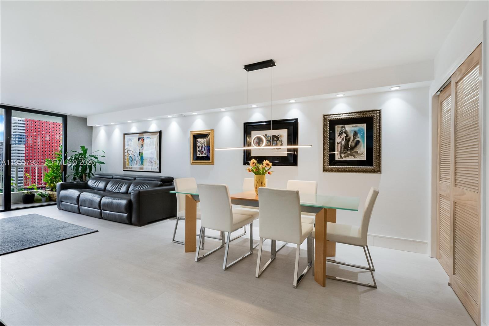 200 Southeast 15th Road, Unit 15C Miami, FL 33129 - Photo 4 of 31 a living room with furniture a rug and a flat screen tv