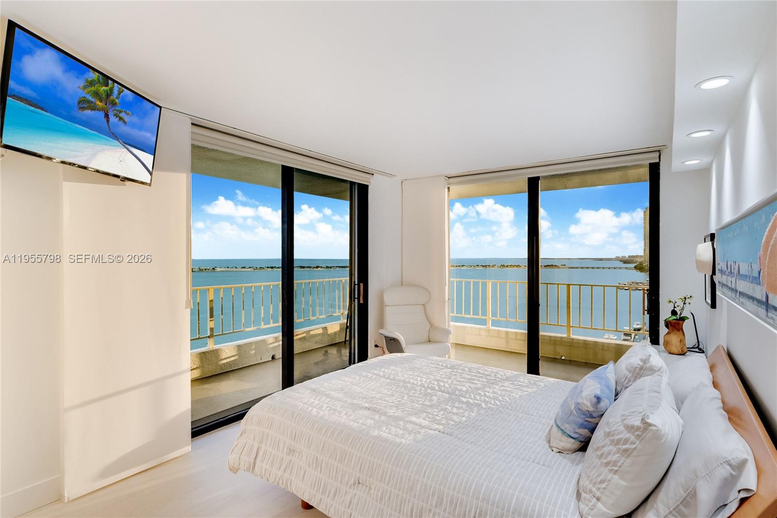 200 Southeast 15th Road, Unit 15C Miami, FL 33129 - Photo 8 of 31 a bedroom with a bed and a flat tv screen next to a window