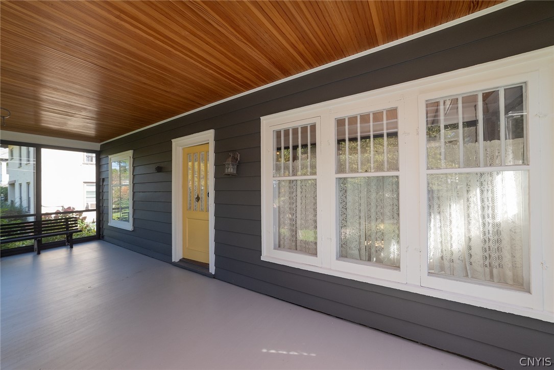 167 Beverly Road Syracuse, NY 13207 - Photo 7 of 50 A spacious covered porch with a warm wood ceiling and classic siding.