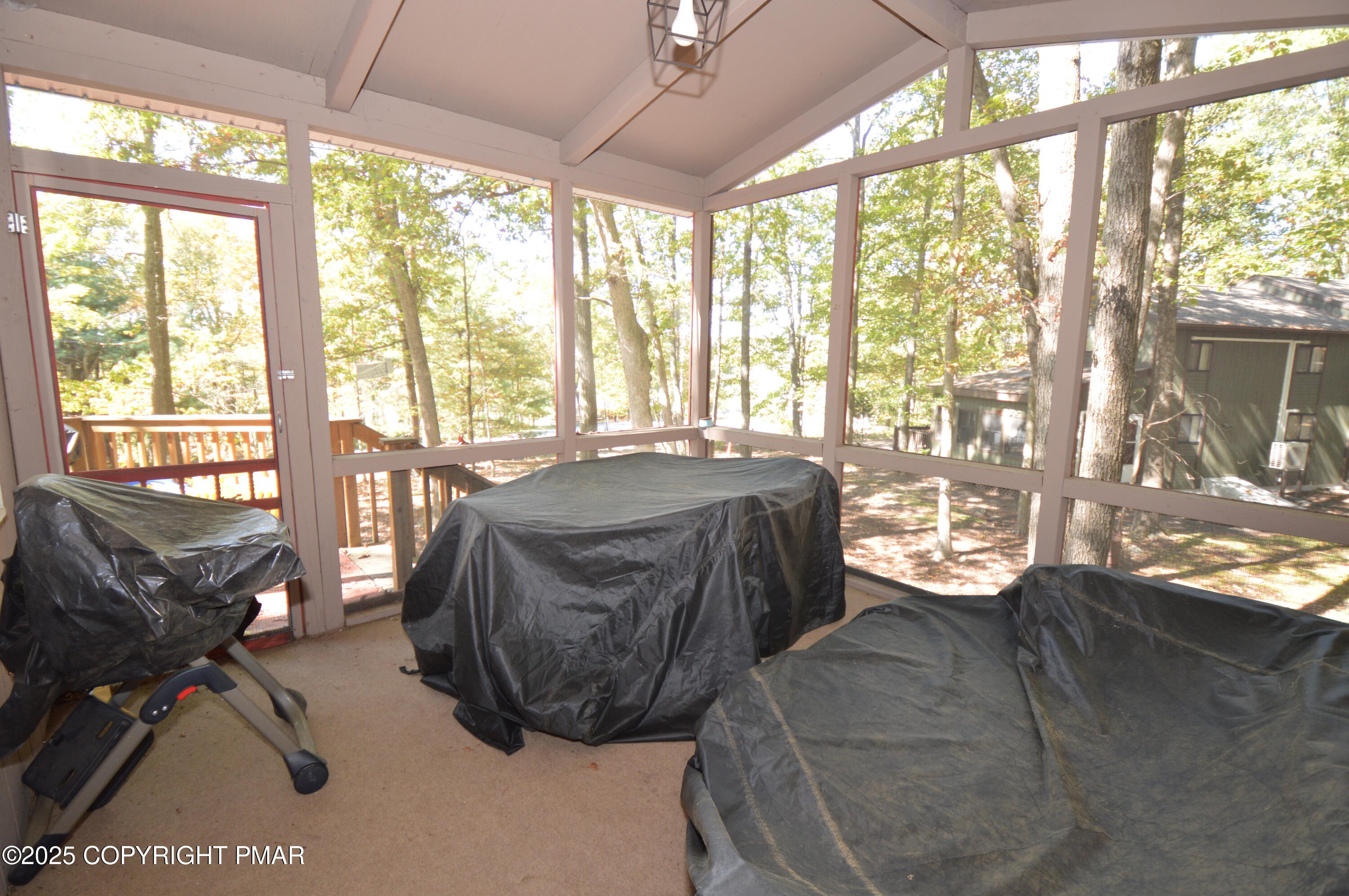 128 Ashley Court Bushkill, PA 18324 - Photo 7 of 43 a living room with couch and a floor to ceiling window