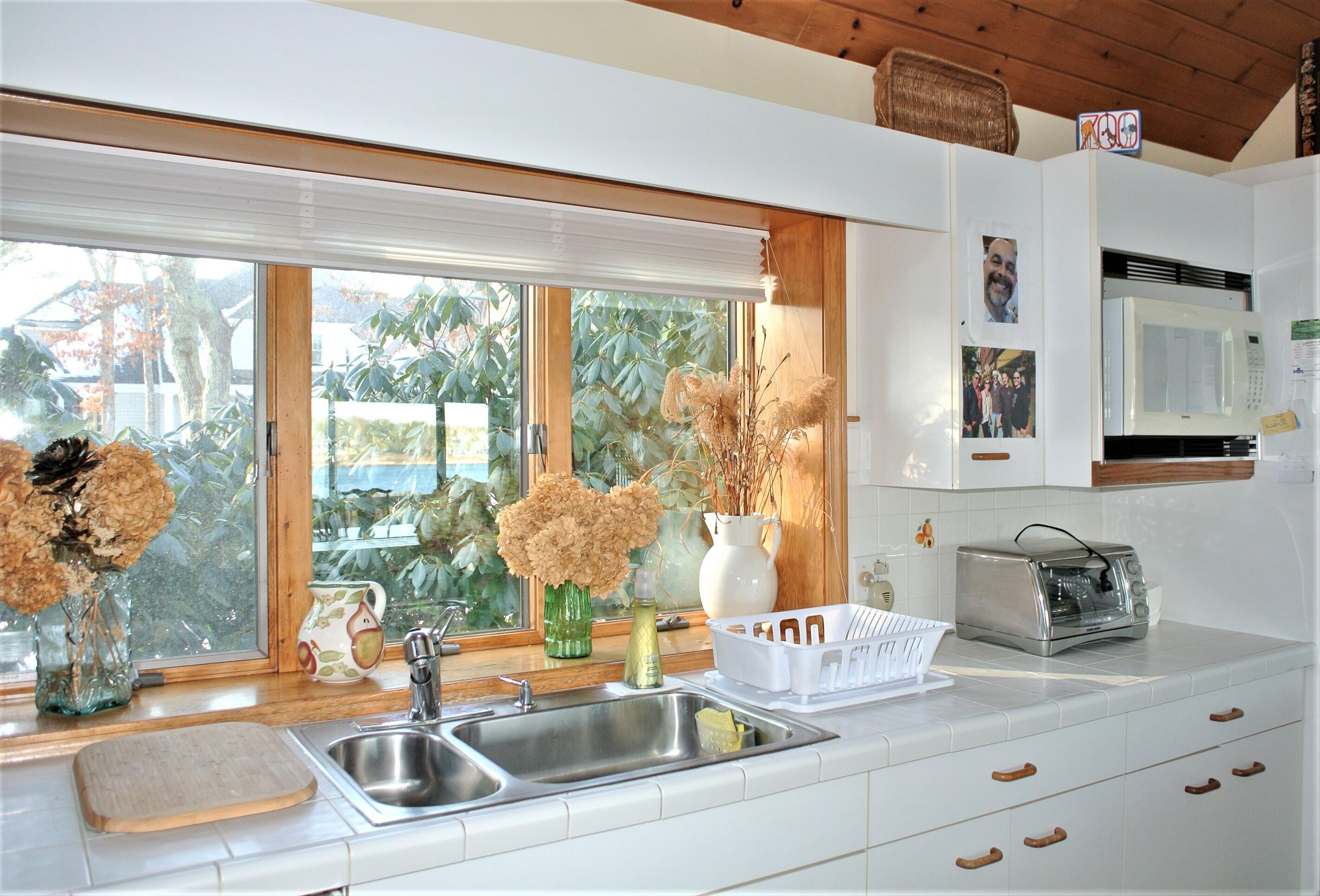 115 Tide Run Mashpee, MA 02649 - Photo 3 of 28 a kitchen with a sink and a window
