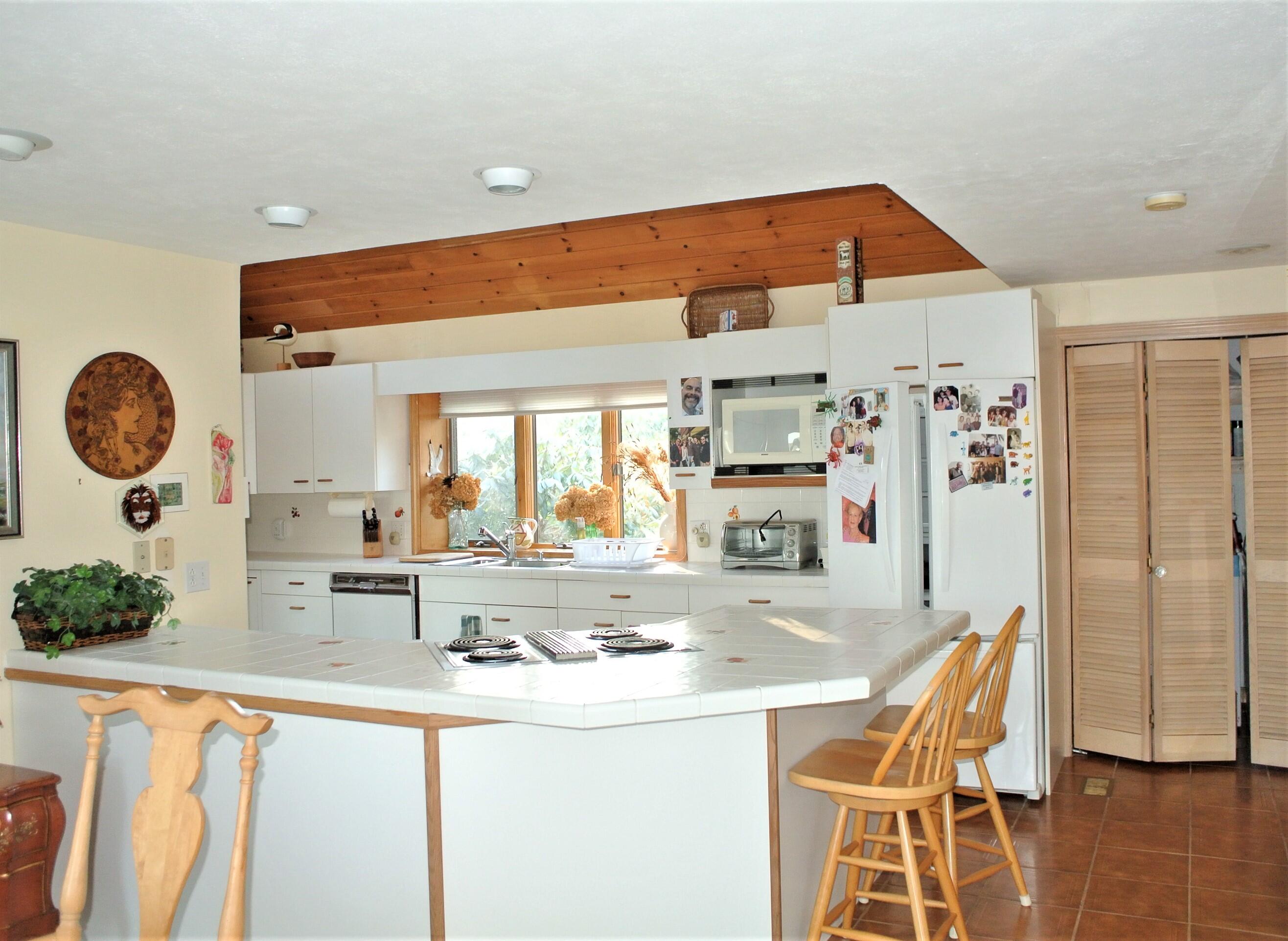 115 Tide Run Mashpee, MA 02649 - Photo 5 of 28 a kitchen with stainless steel appliances granite countertop a sink and a refrigerator