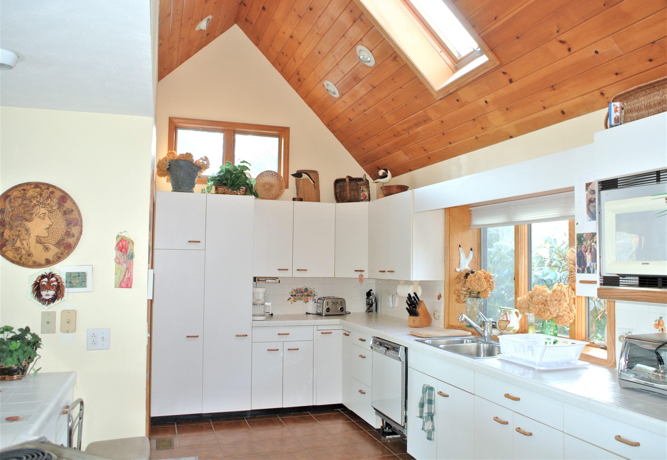 115 Tide Run Mashpee, MA 02649 - Photo 7 of 28 a kitchen with granite countertop white cabinets and white appliances