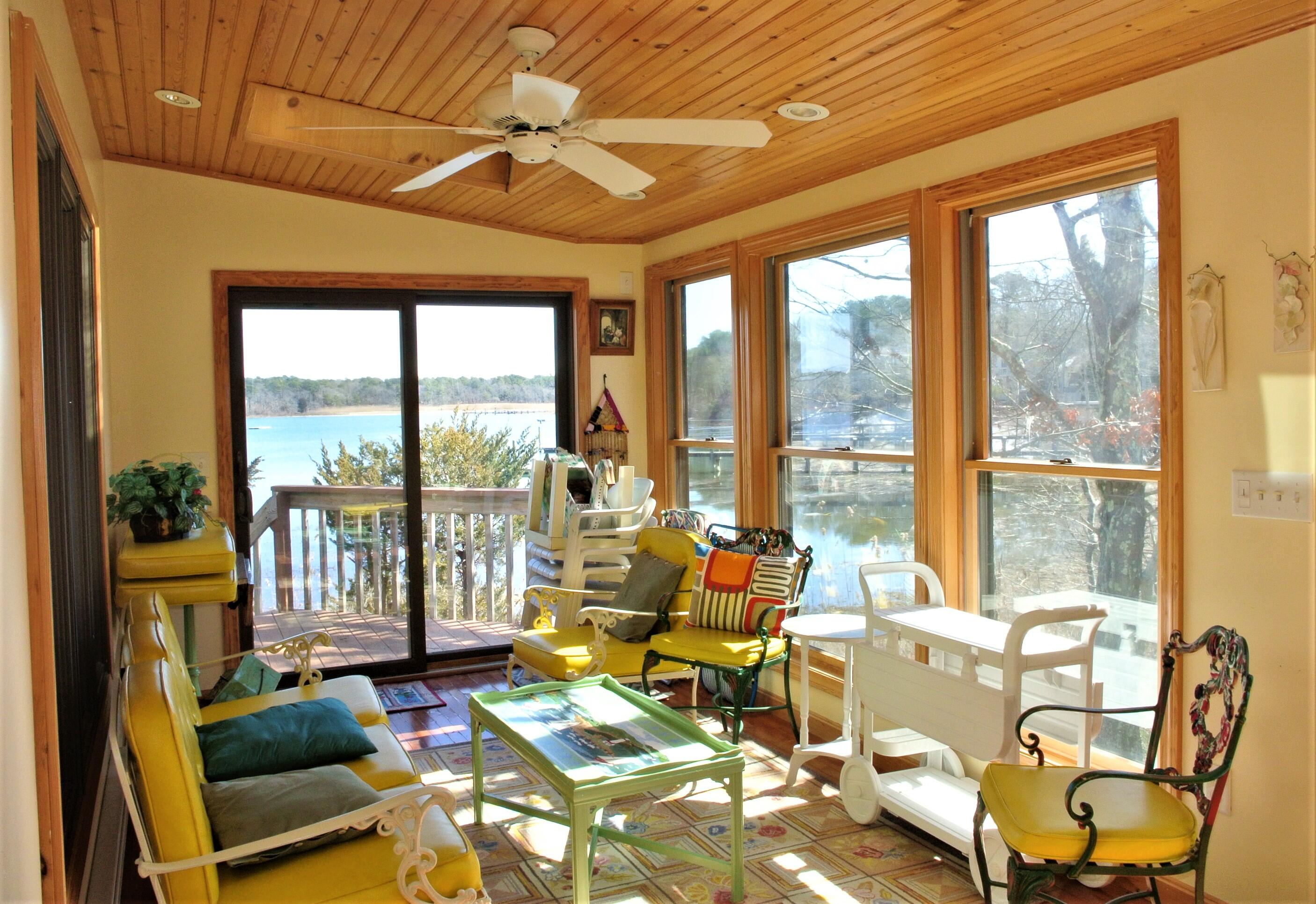 115 Tide Run Mashpee, MA 02649 - Photo 8 of 28 a living room with furniture and floor to ceiling windows