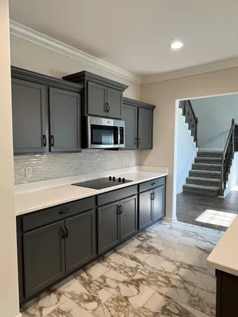 a large kitchen with wooden cabinets and stainless steel appliances