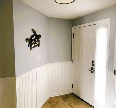 a bedroom with a bed and a wall painting