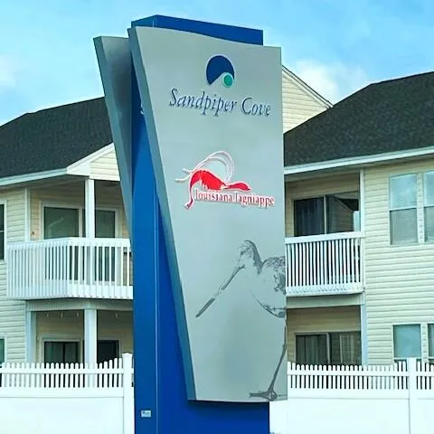 a front view of a building with palm trees