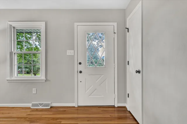 a view of entryway with wooden floor and front door