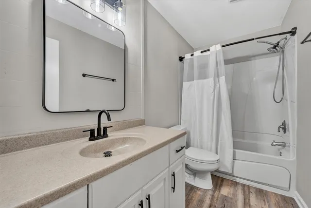 a bathroom with a sink toilet tub and shower