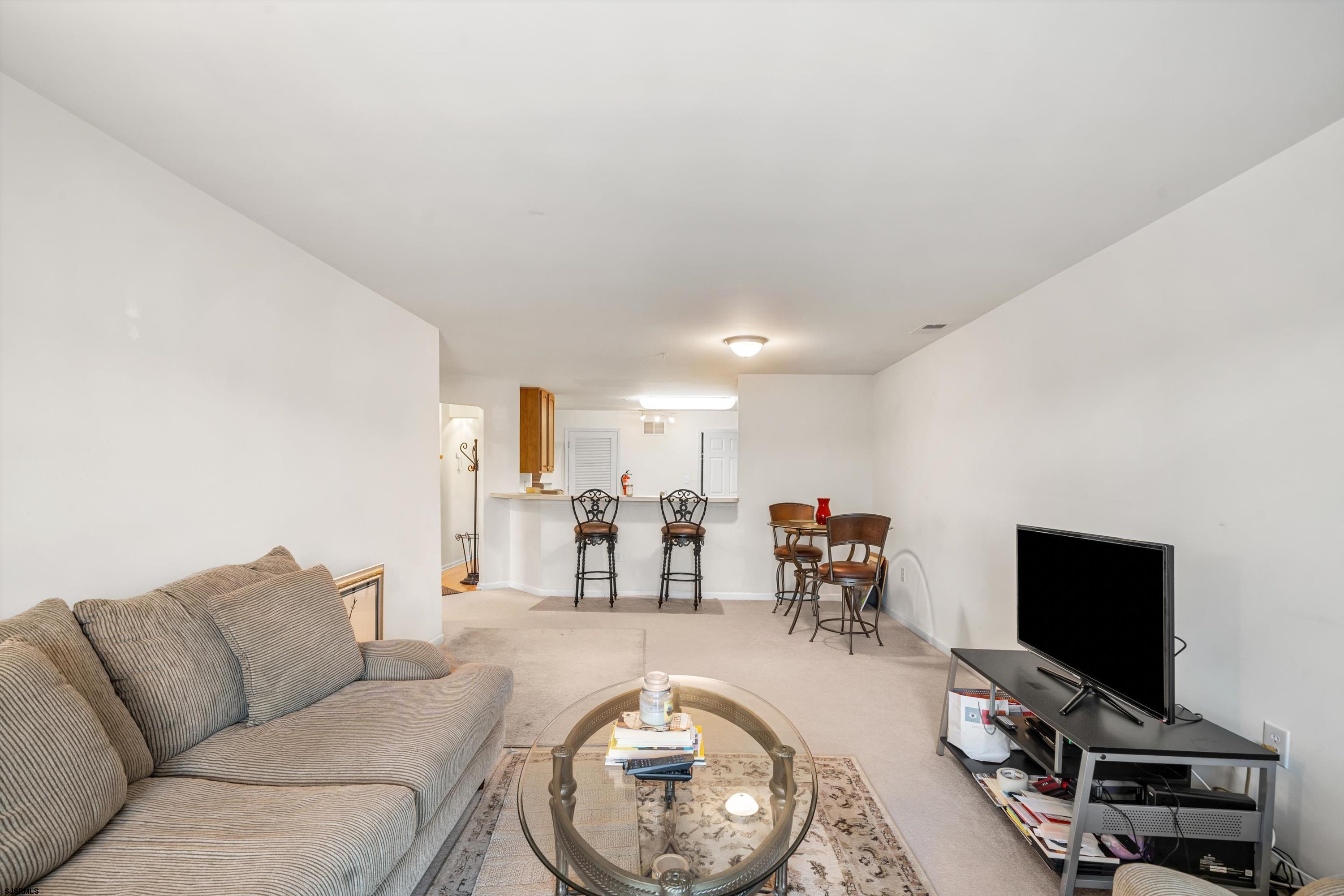 83 Windjammer Drive, Unit 83 Somers Point, NJ 08244 - Photo 12 of 33 a living room with furniture and a flat screen tv