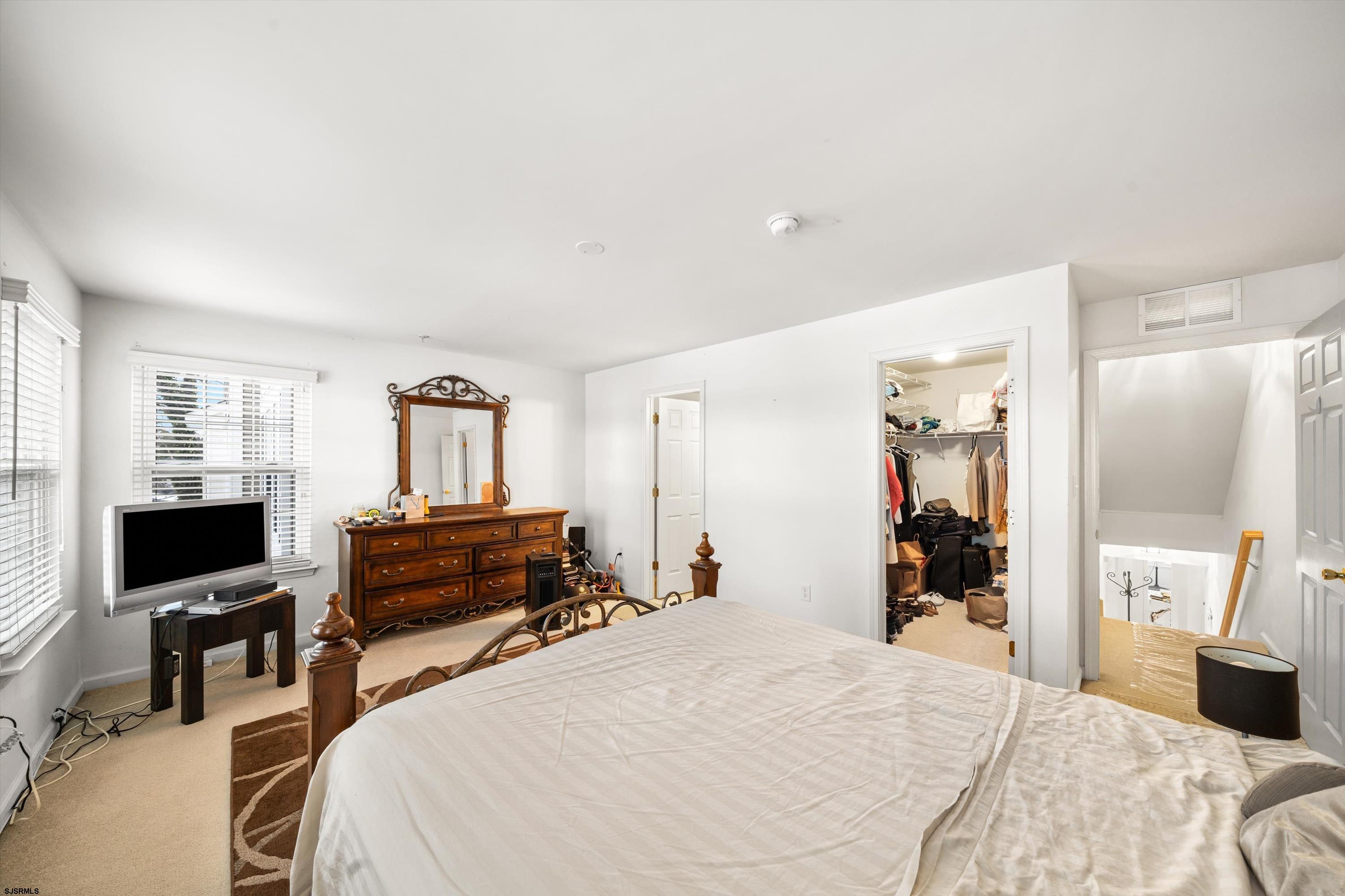 83 Windjammer Drive, Unit 83 Somers Point, NJ 08244 - Photo 25 of 33 a bedroom with a bed and a flat screen tv