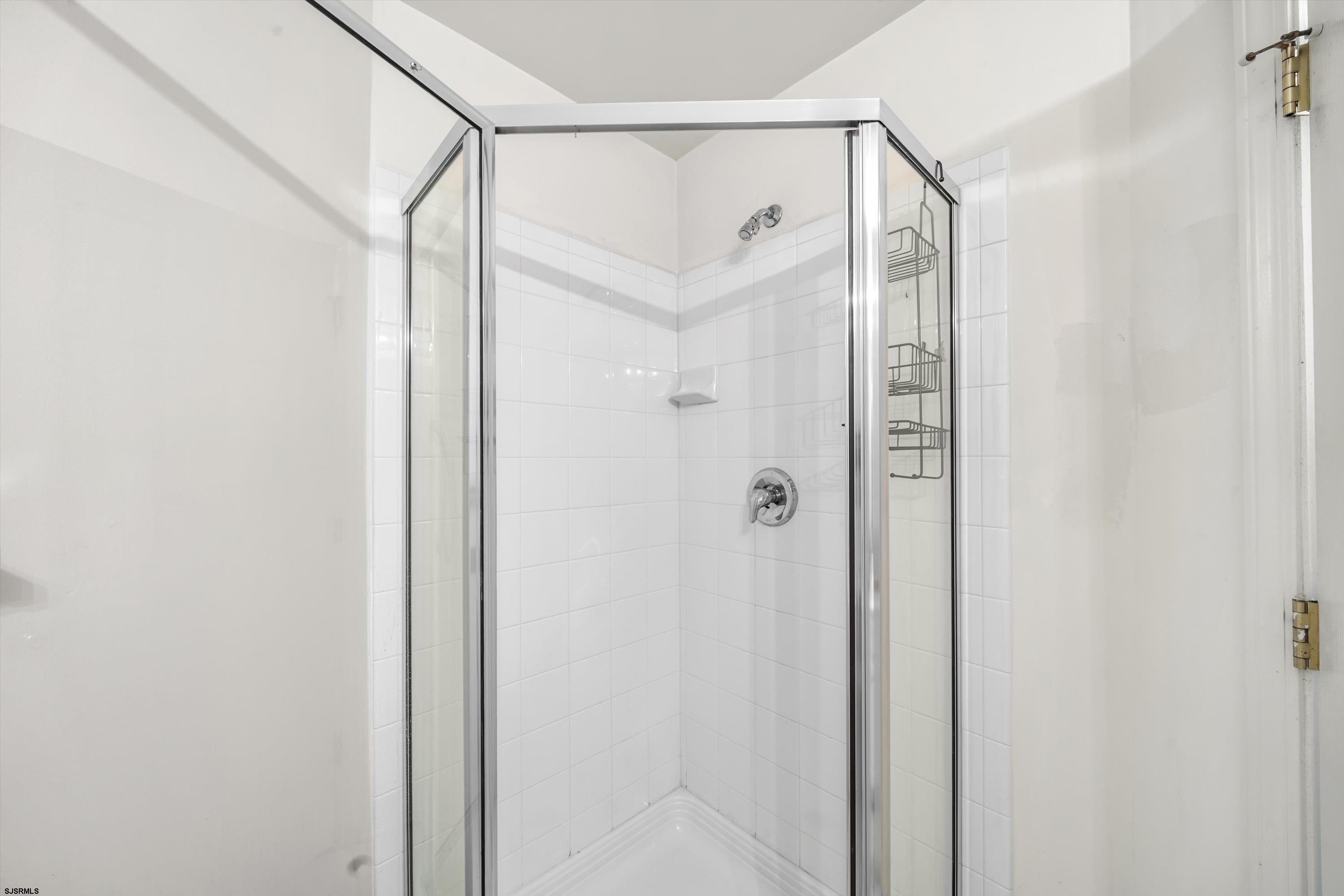 83 Windjammer Drive, Unit 83 Somers Point, NJ 08244 - Photo 32 of 33 a bathroom with a shower and a glass door