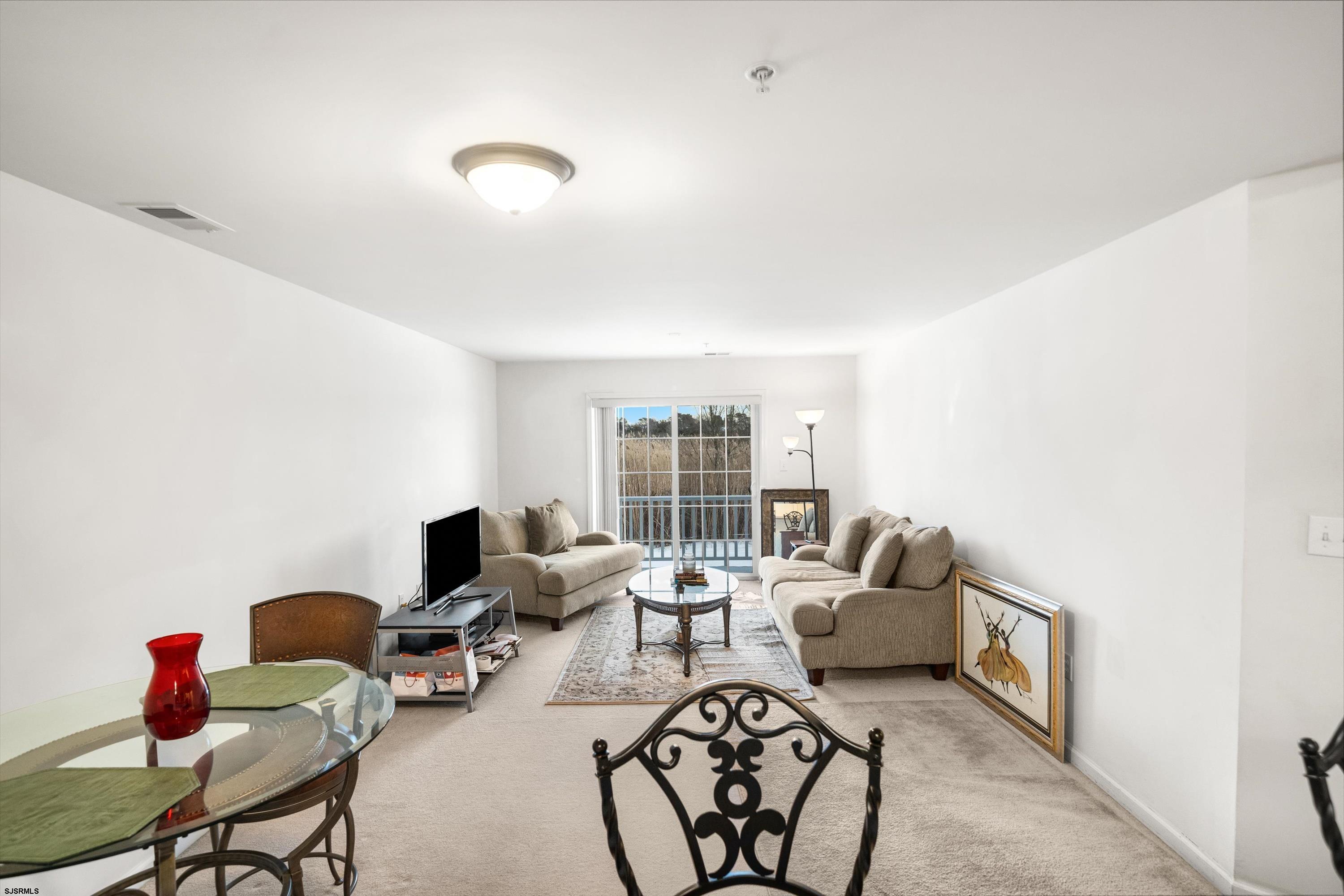 83 Windjammer Drive, Unit 83 Somers Point, NJ 08244 - Photo 10 of 33 a living room with furniture and a window