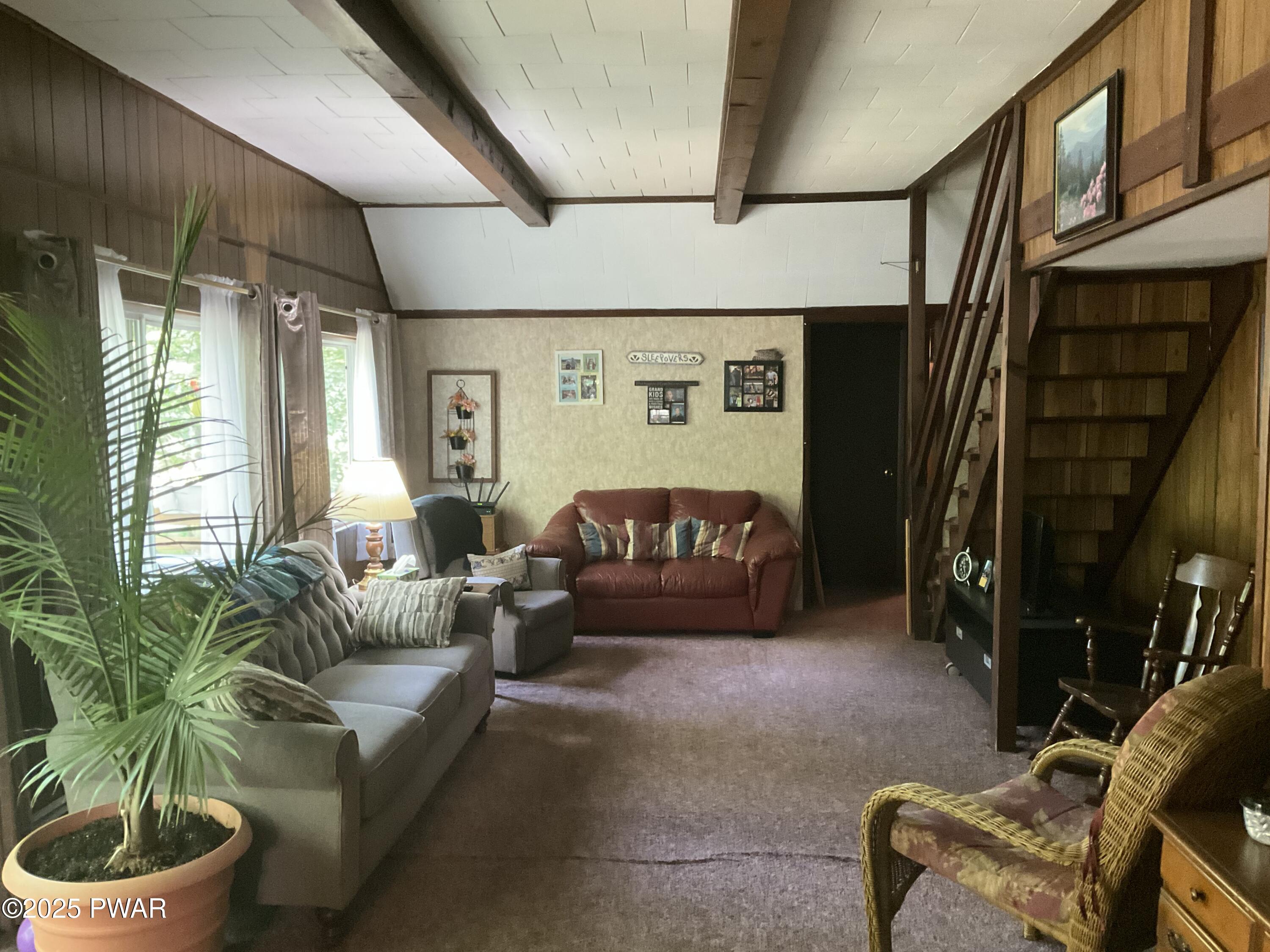 124 Roundhill Road Dingmans Ferry, PA 18328 - Photo 5 of 47 a living room with furniture and a potted plant