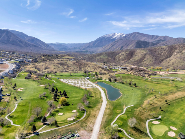 296 West Olympic Lane, Unit 2 Elk Ridge, UT 84651 - Photo 6 of 14 Drone / aerial view of a water and mountain view and a golf club