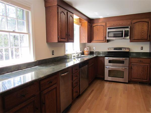 46 Hillcrest Road Weston, MA 02493 - Photo 8 of 21 a kitchen with stainless steel appliances granite countertop wooden cabinets a sink and a stove