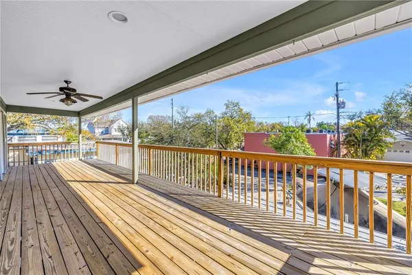 a view of a house with a patio and a yard