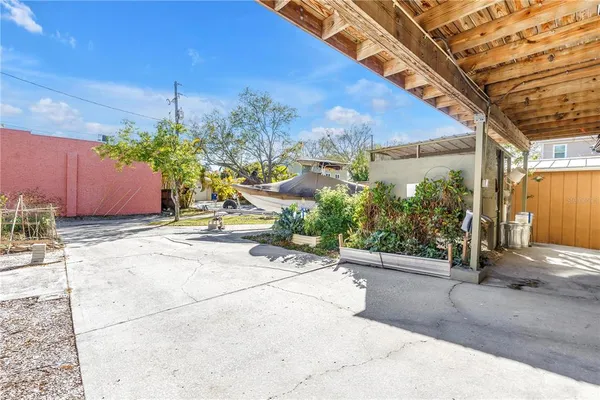 a view of a house with backyard and sitting area