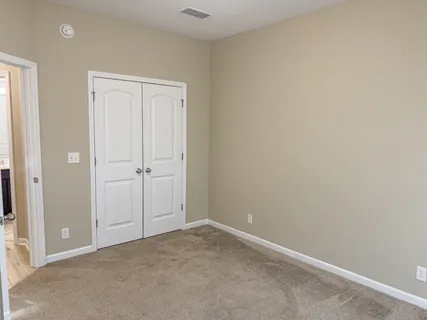 an empty room with closet area