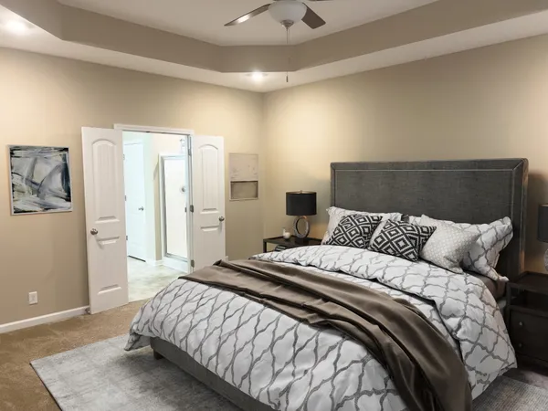 a bedroom with a bed and painting on the wall