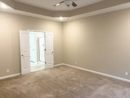 an empty room with a empty space and a ceiling fan