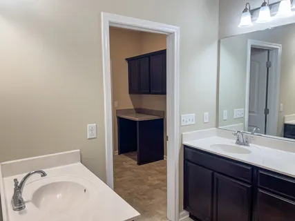 a en suite bathroom with a sink and a mirror
