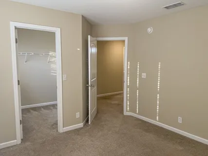 a view of an empty room with windows