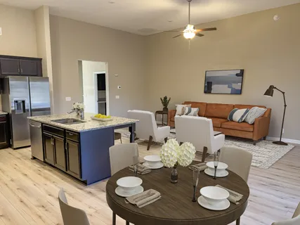a open dining room with furniture kitchen view and wooden floor