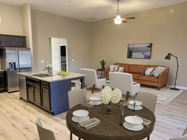 a open dining room with furniture kitchen view and wooden floor
