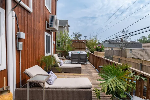 a view of a patio with couches table and chairs and potted plants
