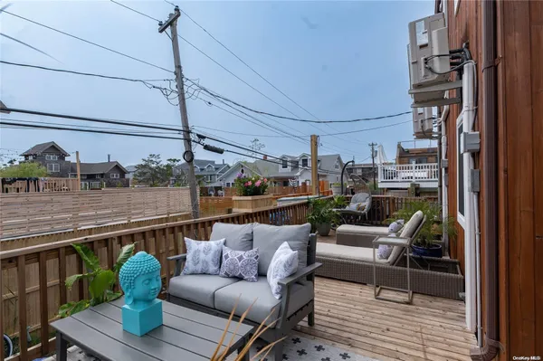 a balcony with couple of cars parked on road