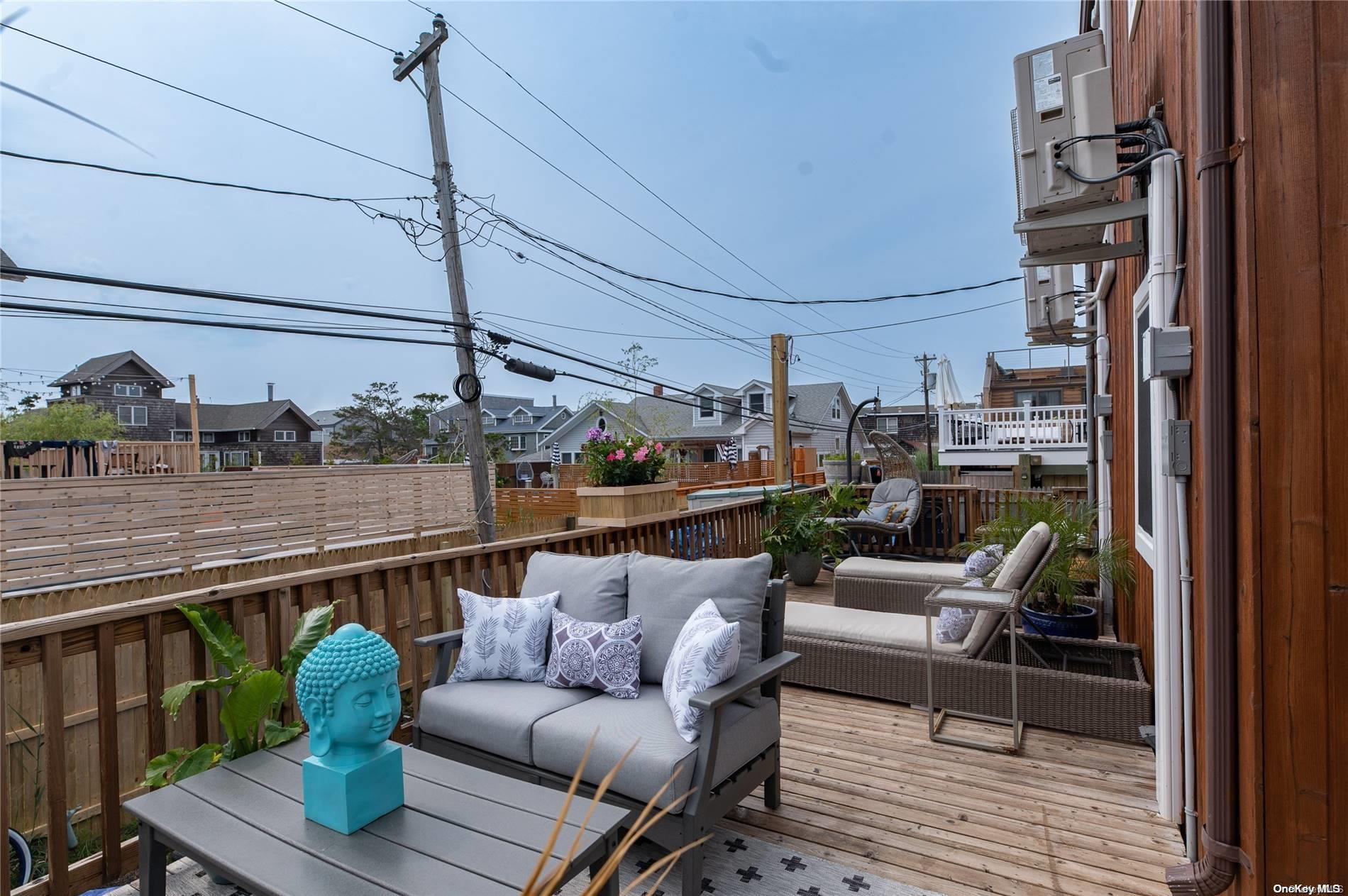 337 Dehnhoff Ocean Beach, NY 11770 - Photo 14 of 14 a balcony with couple of cars parked on road