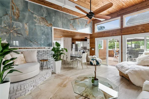 a living room with furniture and potted plants