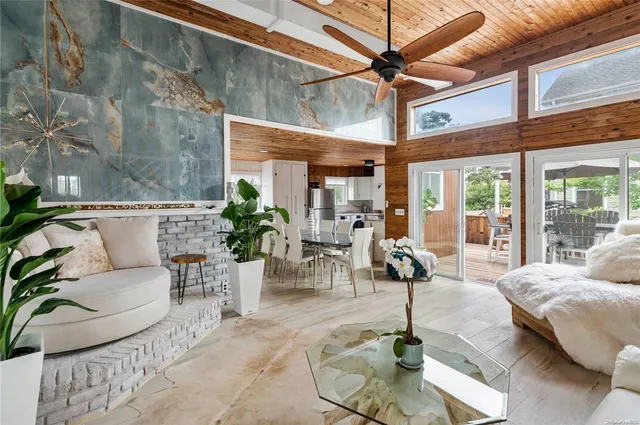 a living room with furniture and potted plants