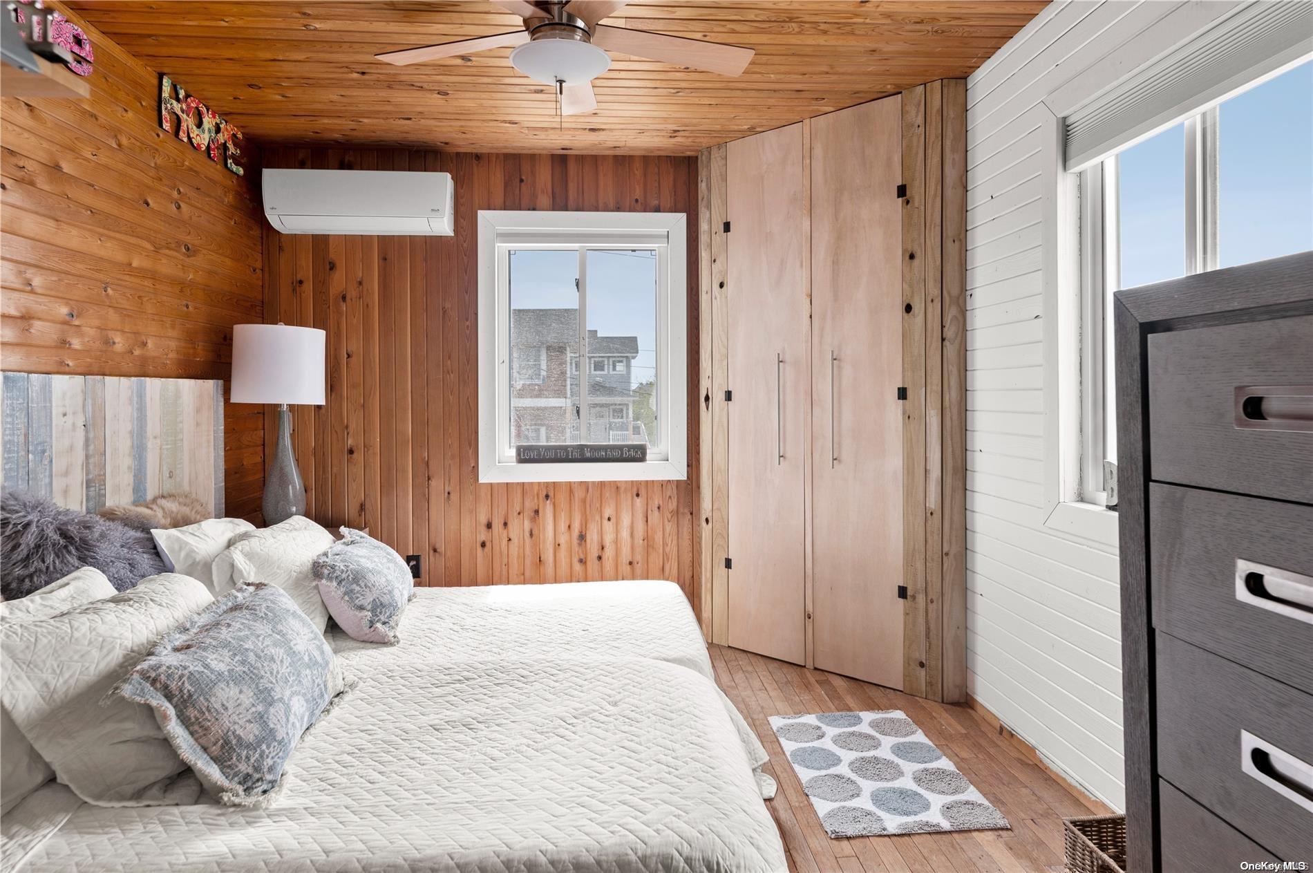 337 Dehnhoff Ocean Beach, NY 11770 - Photo 9 of 14 a bedroom with a bed and a window