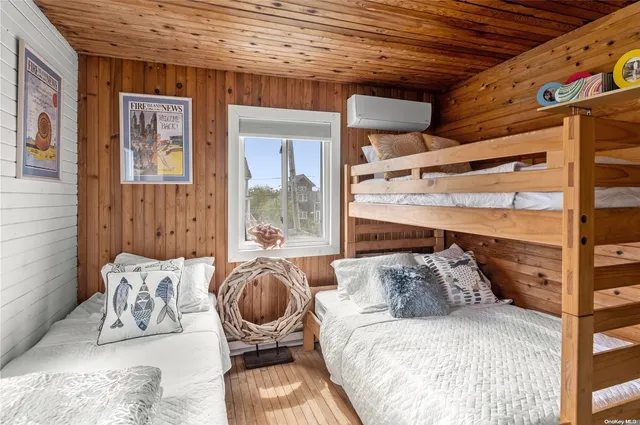 a bedroom with a bed and glass window